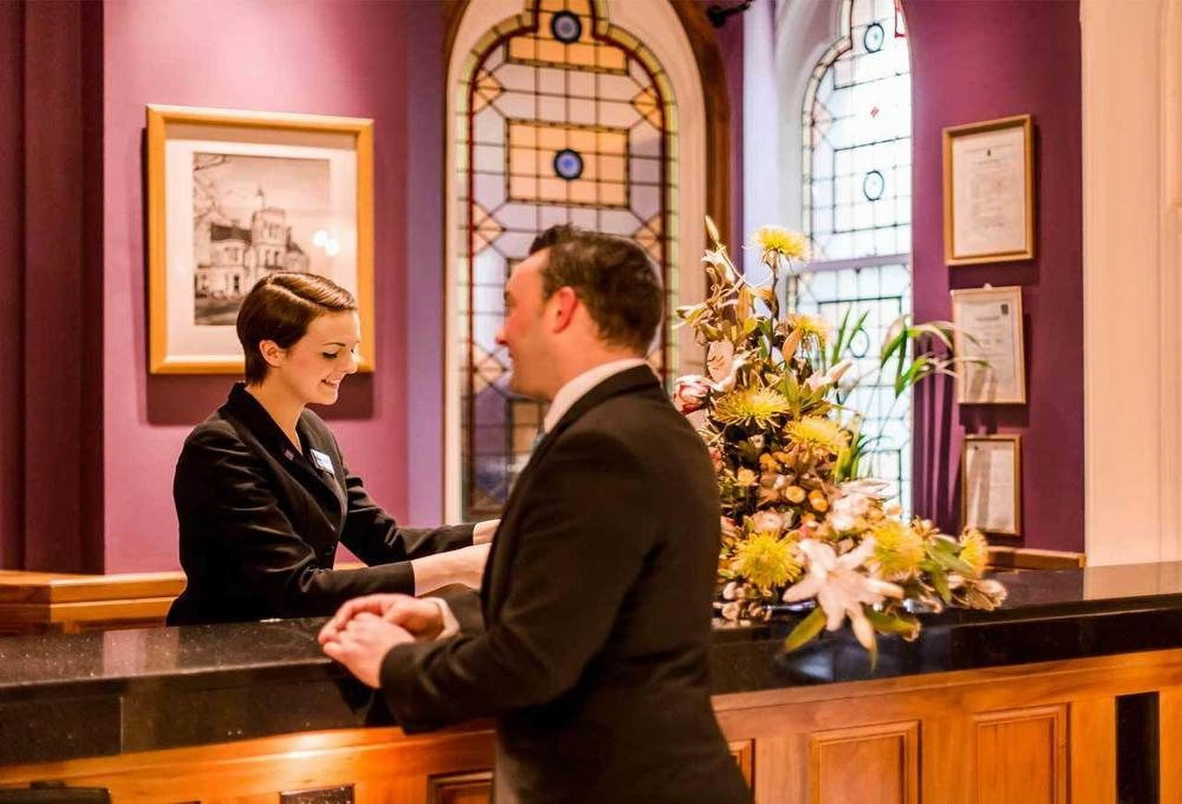 The Culloden Estate And Spa Holywood  Exterior photo A hotel receptionist at work